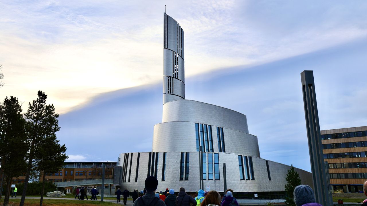 a large titanium-clad church in a spiral shape echoing the shapes that the northern lights can take.