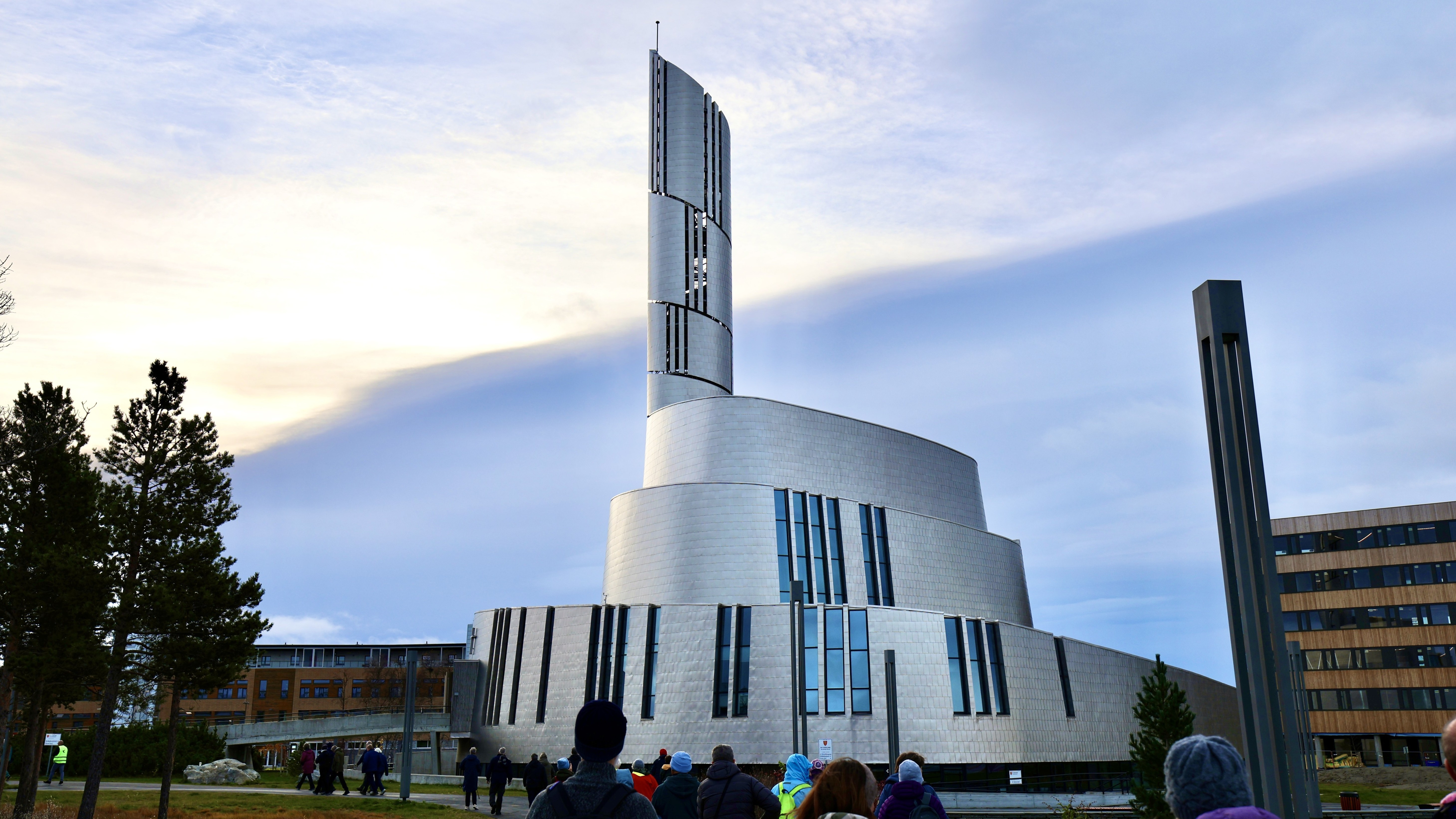 a large titanium-clad church in a spiral shape echoing the shapes that the northern lights can take.