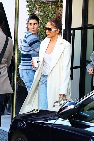 Jennifer Lopez in a white coat and rare Birkin bag while shopping in Los Angeles.