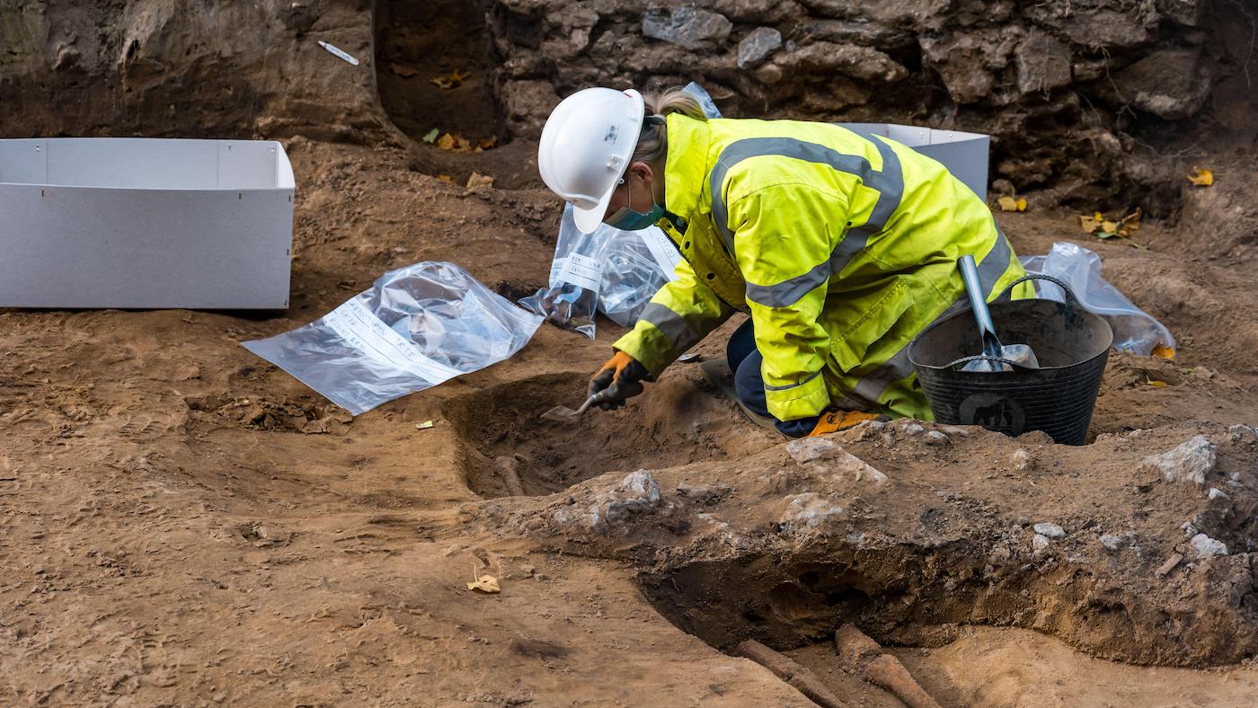 Archaeological dig of Medieval skeleton in burial site, Constitution Street, Leith, Edinburgh, Scotland, UK during tram line construction work
