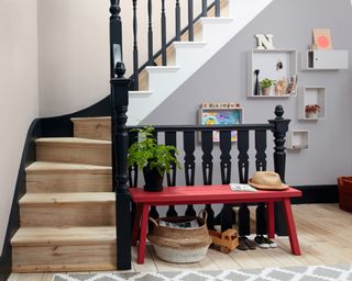 Modern hallway idea by Dulux with black banister, red bench and modular shelves