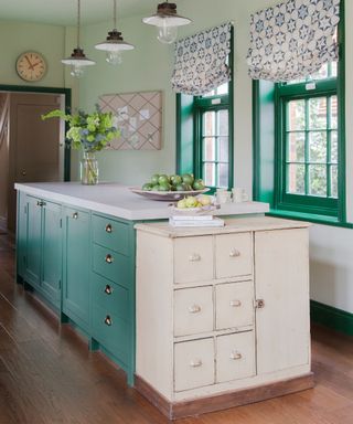 kitchen island color ideas, green kitchen with green painted island, green painted window frames, patterned blinds, vintage cabinet, pendant lights