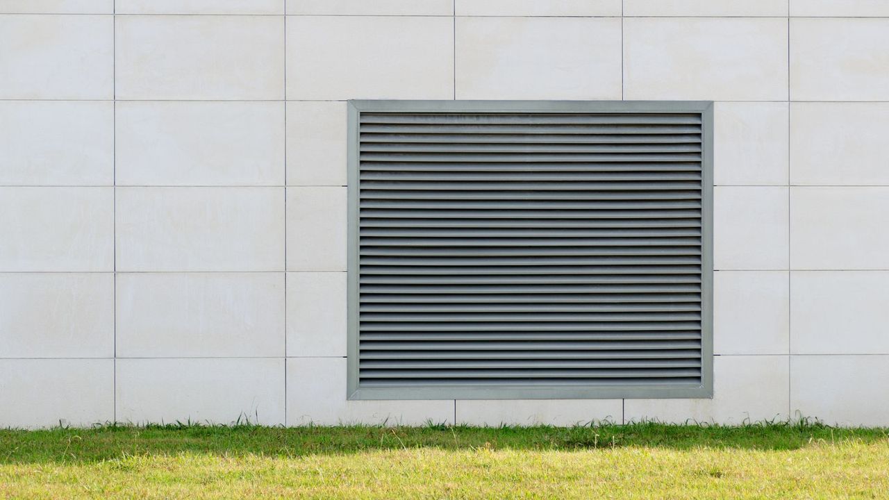 Lattice shutters vent cover on the wall of the house