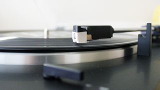 Audio-Technica AT-LP60XBT turntable close up of cartridge playing record