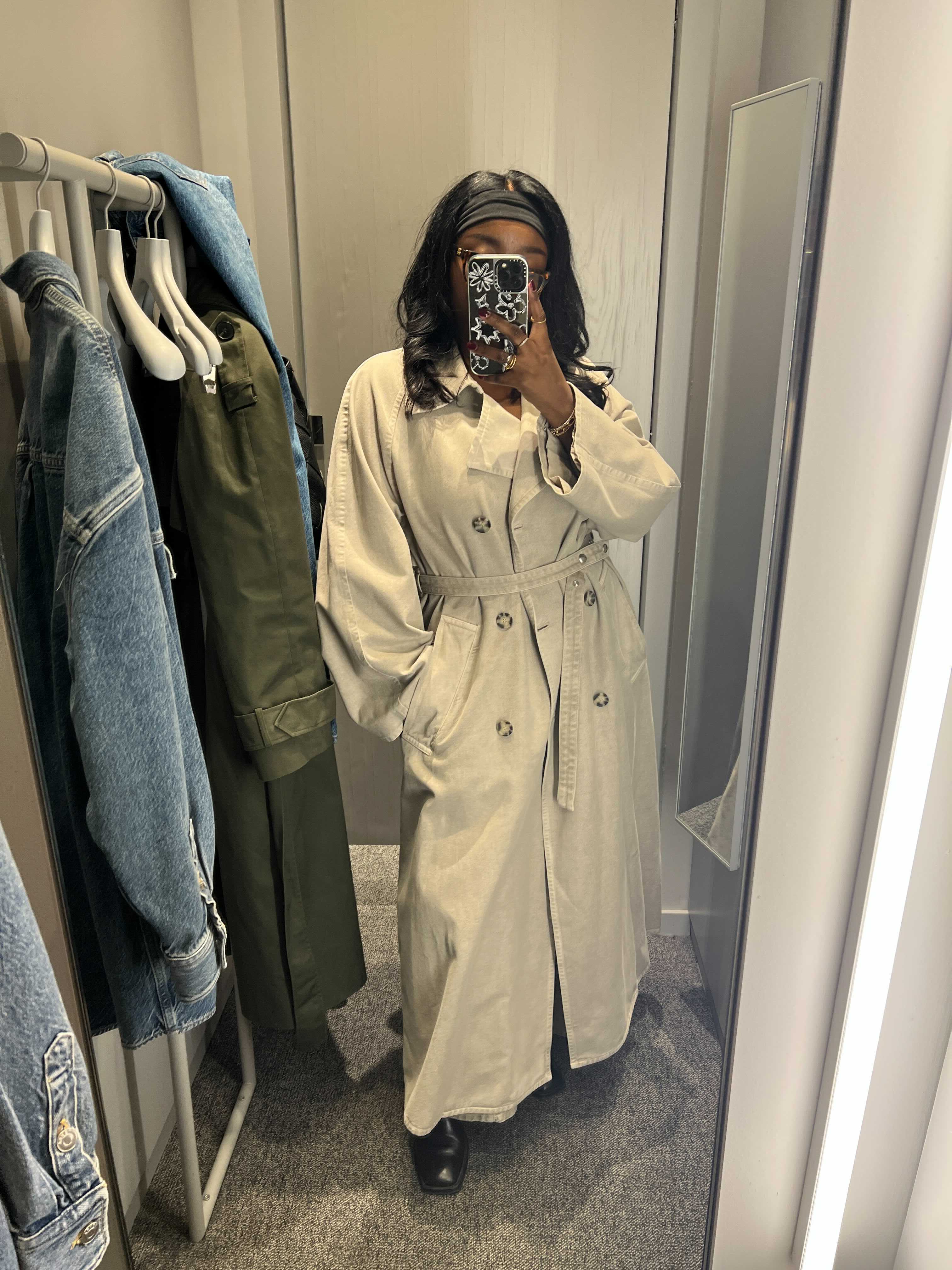 Remi wears the Arket garment-dyed trench coat