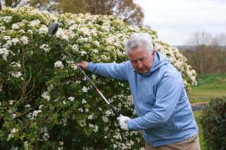 Golfer with impeded backswing on the tee