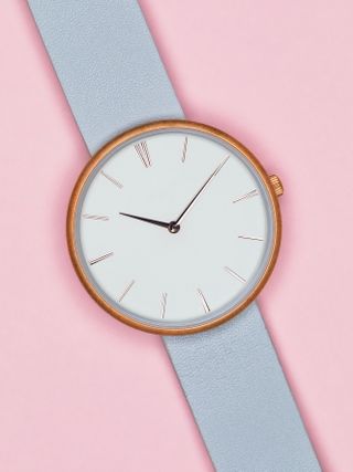 product photography with a grey watch on a pink background