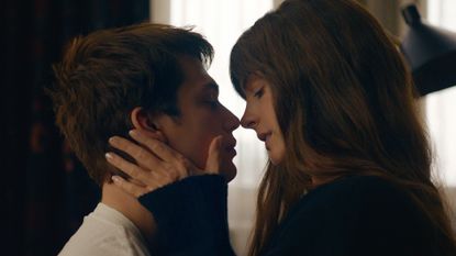 Nicholas Galitzine and Anne Hathaway, about to kiss in a hotel room, in 'The Idea of You'