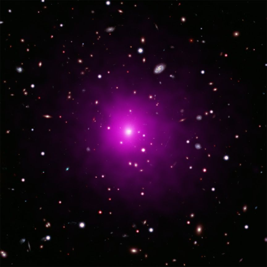 This composite image of the galaxy cluster Abell 2261 contains optical data from NASA&#039;s Hubble Space Telescope and Japan&#039;s Subaru Telescope showing galaxies in the cluster and in the background, and data from NASA&#039;s Chandra X-ray Observatory showing hot gas (colored pink) pervading the cluster. The middle of the image shows the large elliptical galaxy in the center of the cluster.