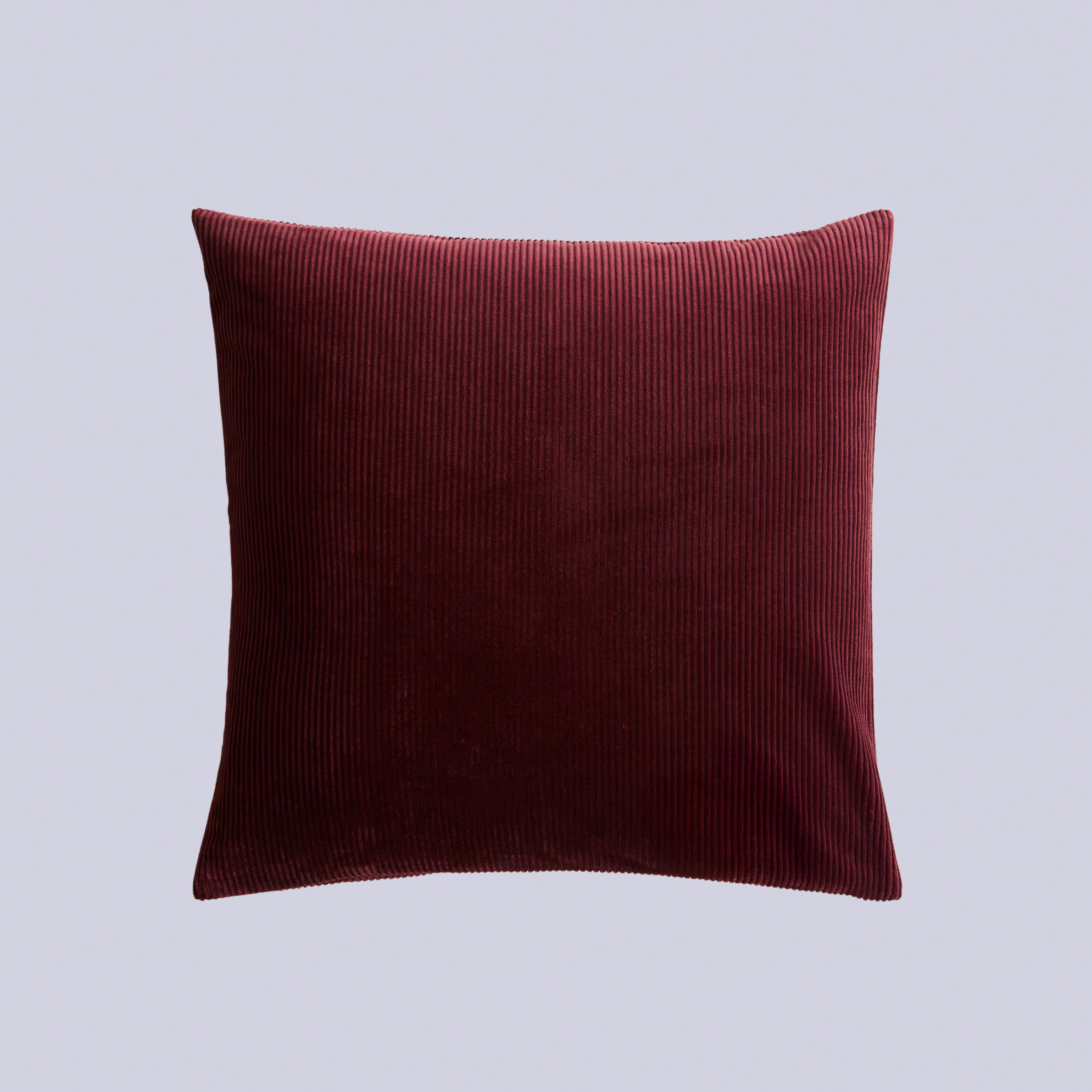 A burgundy corduroy throw pillow
