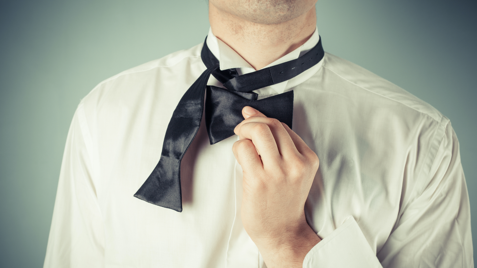 How to tie a bow tie - fold the shorter half and keep it level