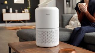 Levoit Core 33 air purifier on wooden table