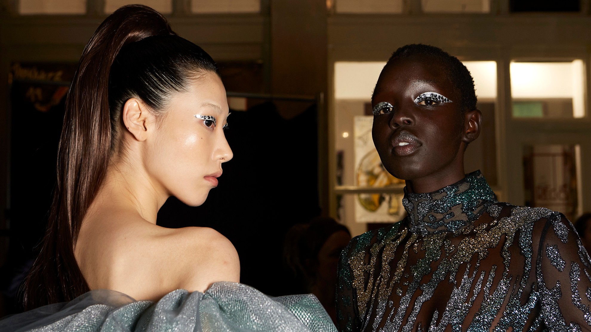 Two models pose with sequin eyeshadow: just one of many great NYE makeup ideas.