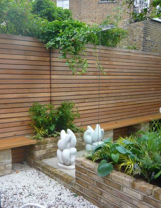 small garden with a mirrored wall to maximise the feeling of space