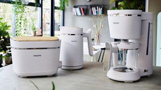 A selection of Philips home appliances sitting on a kitchen counter in a modern decor kitchen