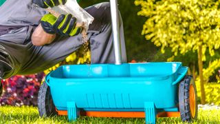 Man putting fertlizer in sprayer for lawn