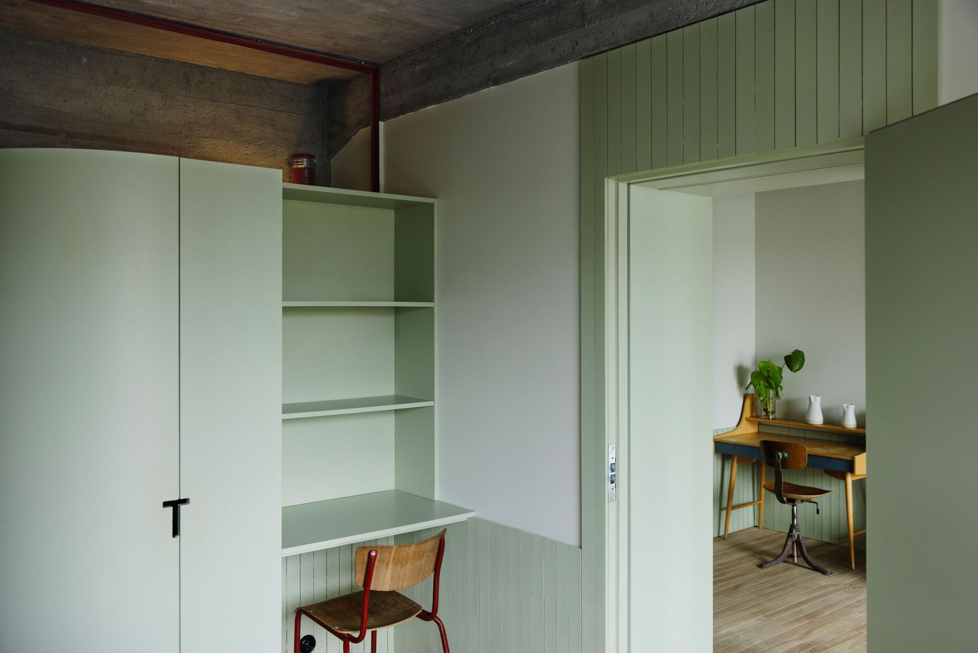 Pale green-panelled bedroom at trevarefabrikken hotel Norway