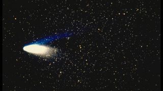 image of a comet - halleys comet - bright a bright core against a starry sky.
