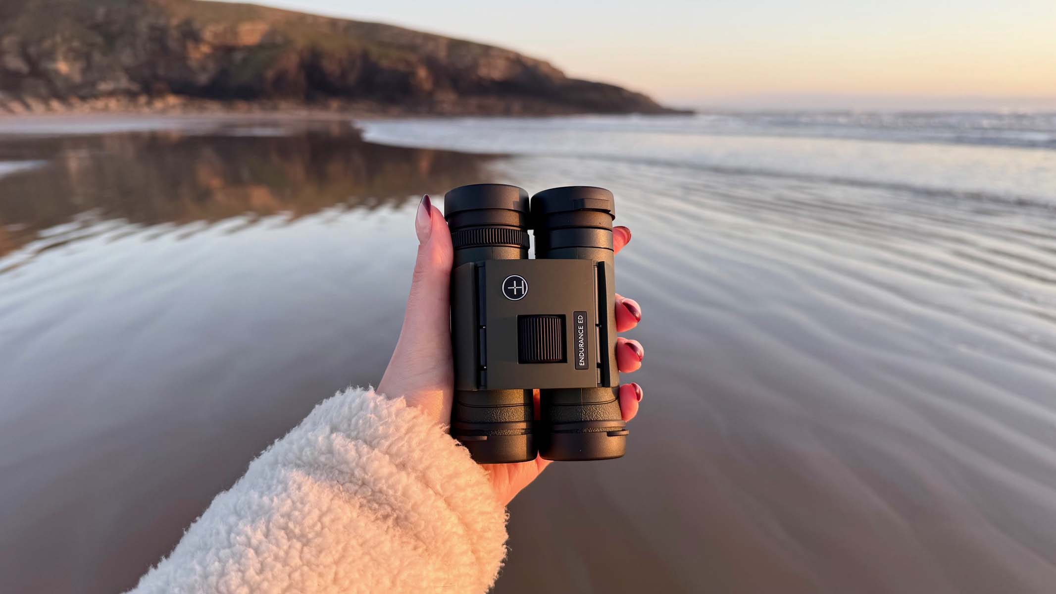 Hawke Endurance ED 8x25 in the hand at a coastal location