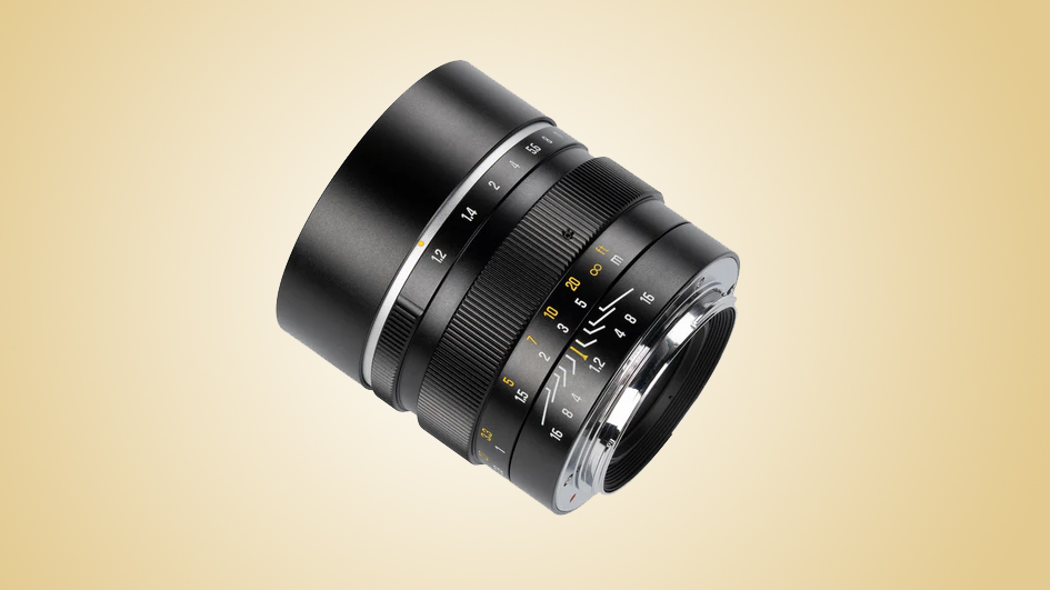 The 7Artisans MF 50mm f/1.2 on a gold gradient background