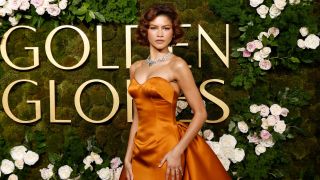 Zendaya posing on the 2025 Golden Globes red carpet with her ring showing on her finger.