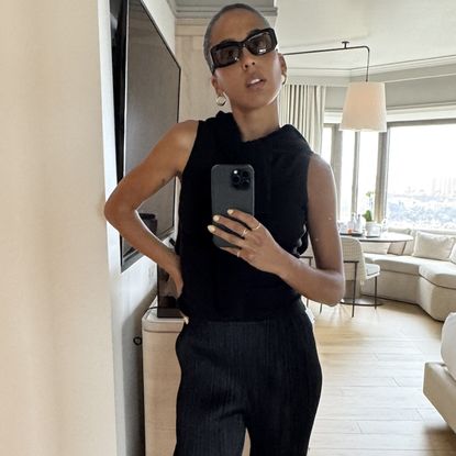 Madison Utendahl posing while wearing pleats please issey miyake with white border