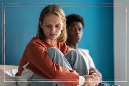 woman looking away from her partner with worried look on her face