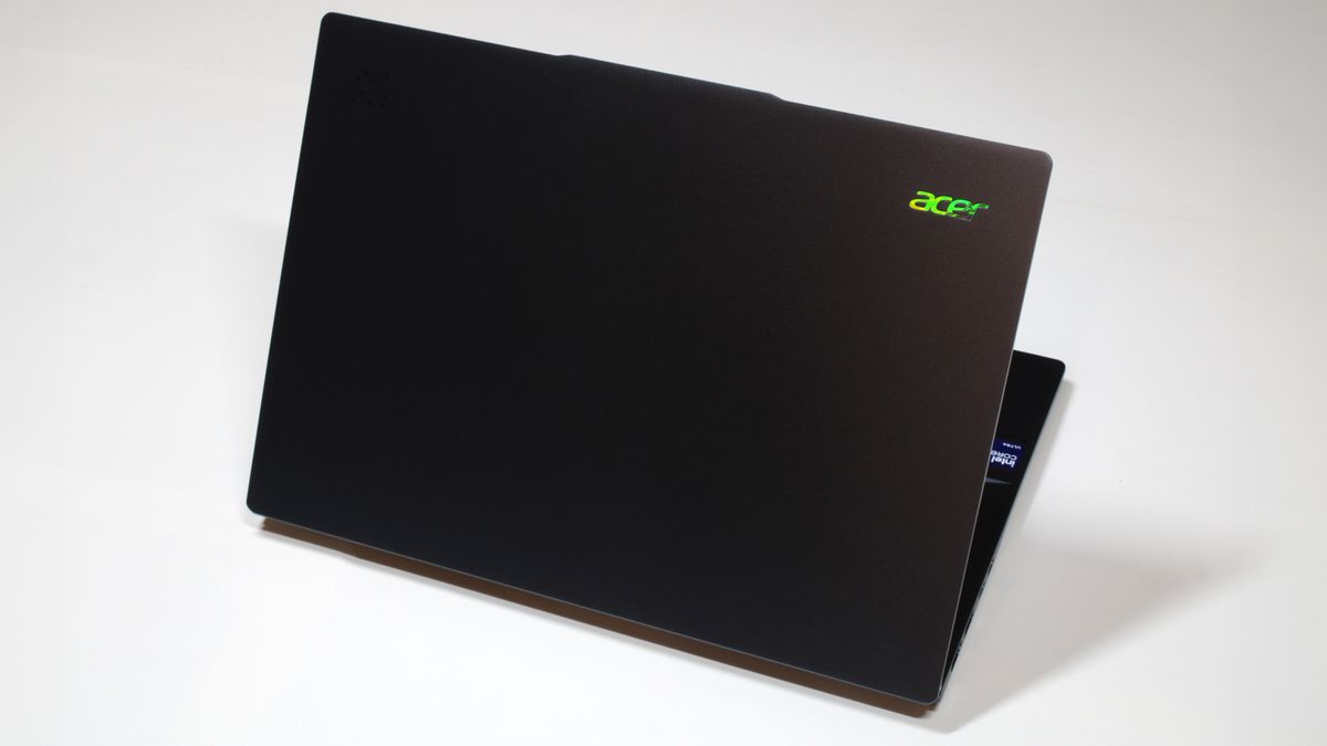 Acer Swift 14 AI (Intel) open with the lid facing the camera and demonstrating prismatic effect on Acer logo