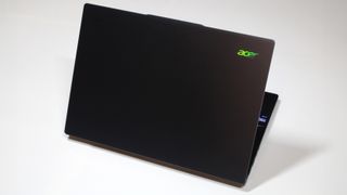 Acer Swift 14 AI (Intel) open with the lid facing the camera and demonstrating prismatic effect on Acer logo