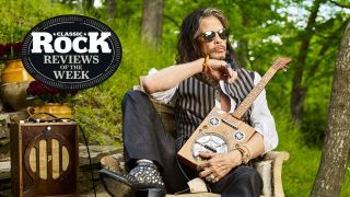A photograph of Steven Tyler sat outside with a range of vintage instruments