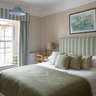 green bedroom with frame on wall