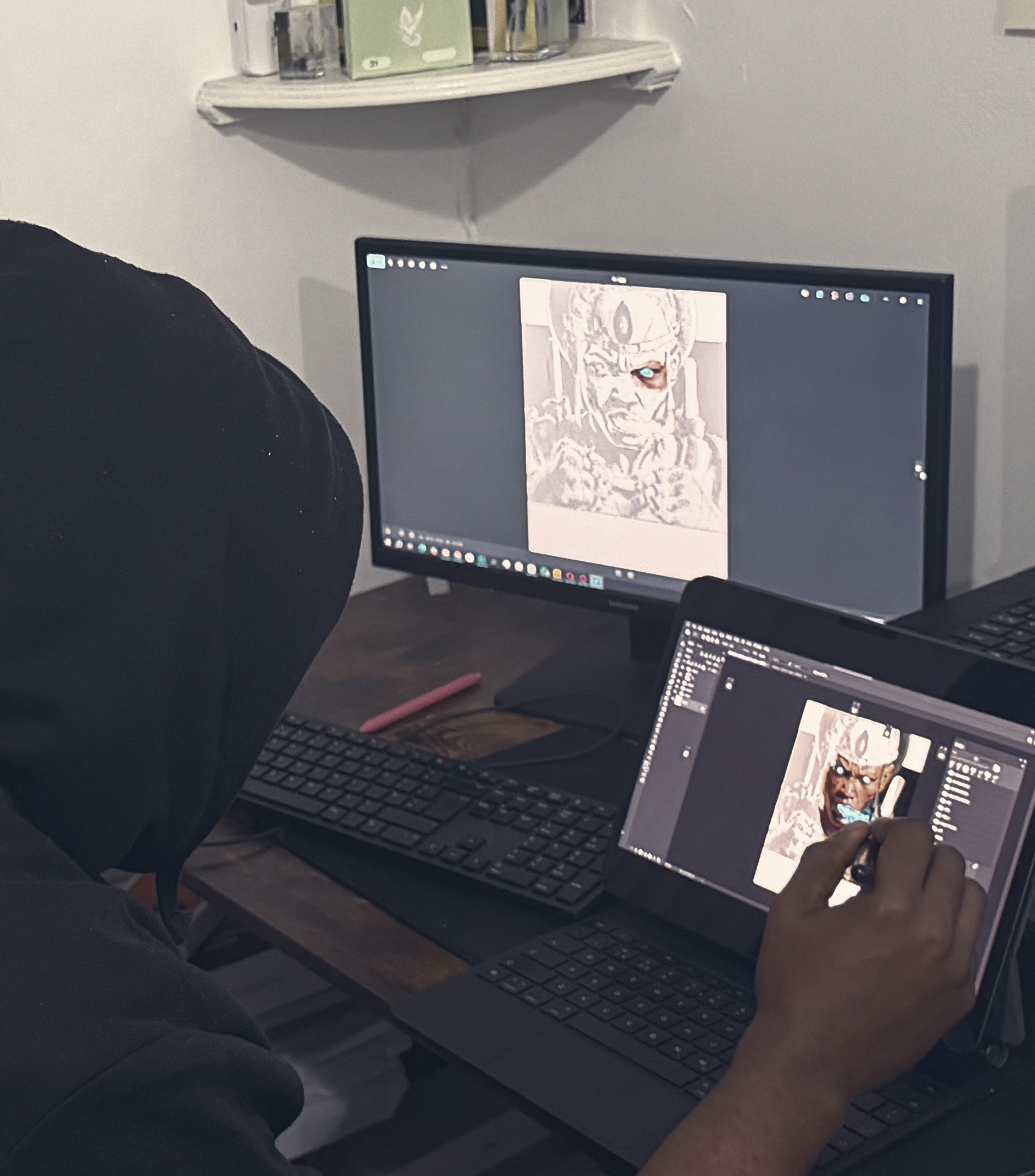 drawing tablets; an artist's hand using a stylus on a tablet screen showing a fantasy scene