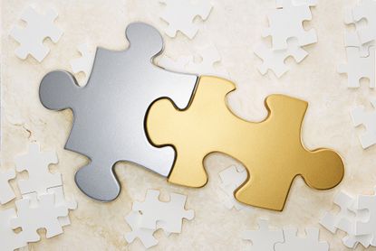 picture of interlocking gold and silver puzzle pieces