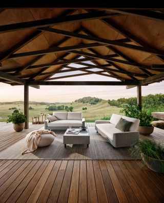 wooden covered patio with decking, rug and outdoor furniture