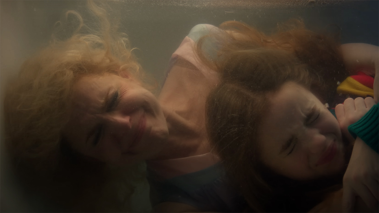 Karen and Holly Wheeler holding their beath and hiding in a bath of water in Stranger Things season 5