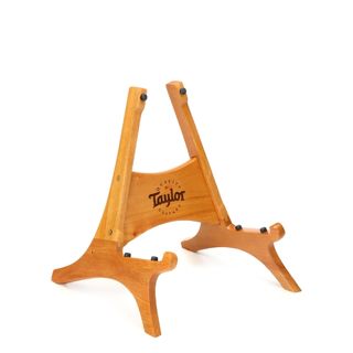 A wooden Taylor acoustic guitar stand