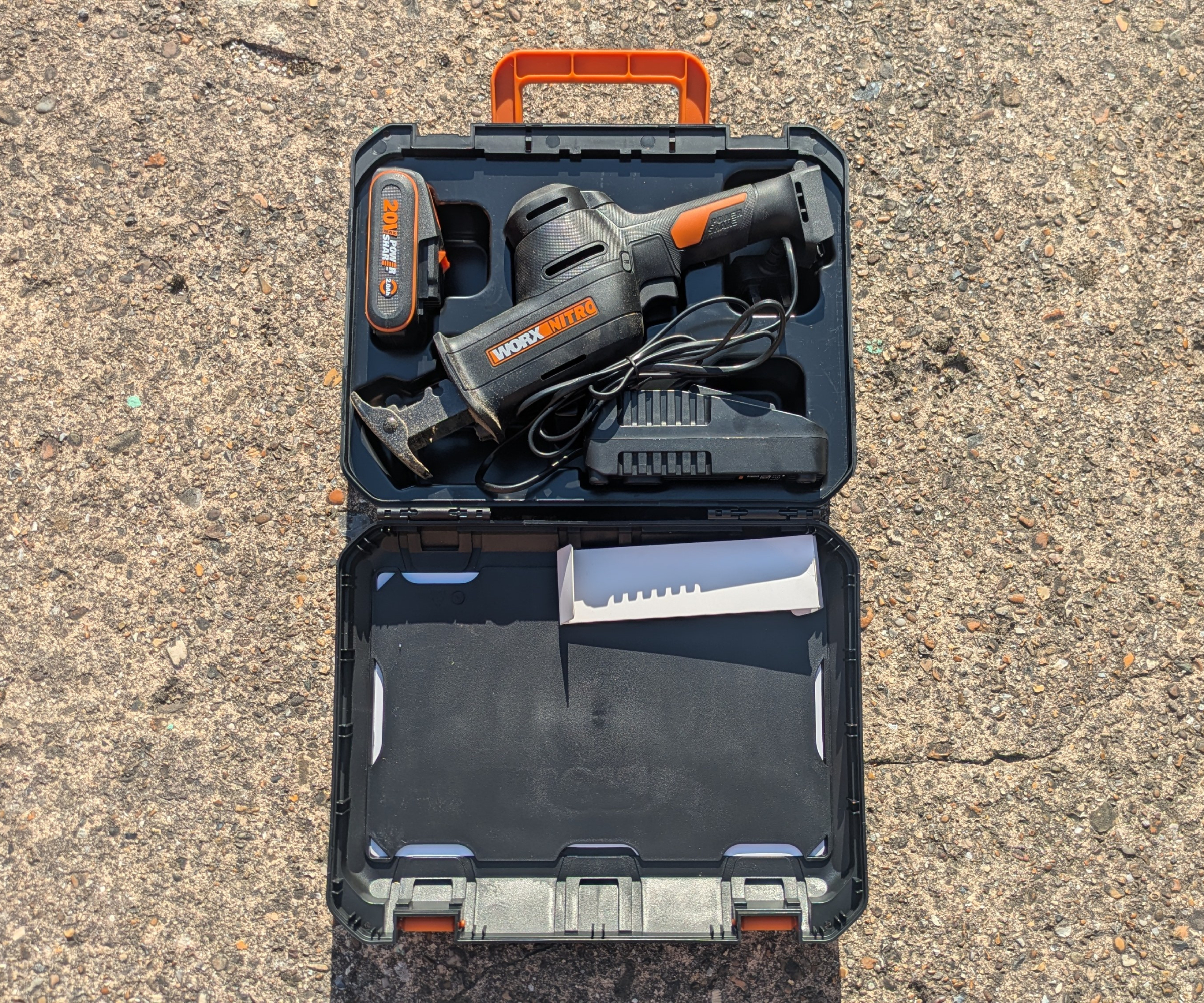 The Worx reciprocating saw shown with its accessories within its open case