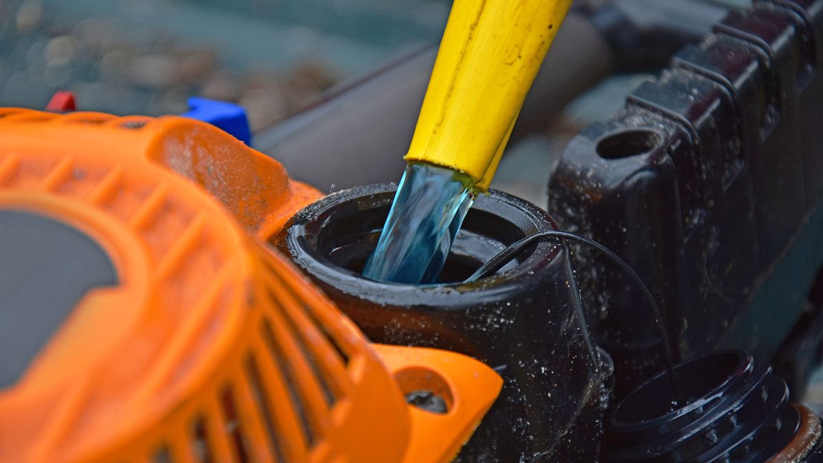 Gas being poured into chainsaw