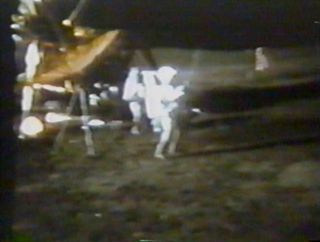 a film still of an astronaut in a white spacesuit swinging a golf club on the moon