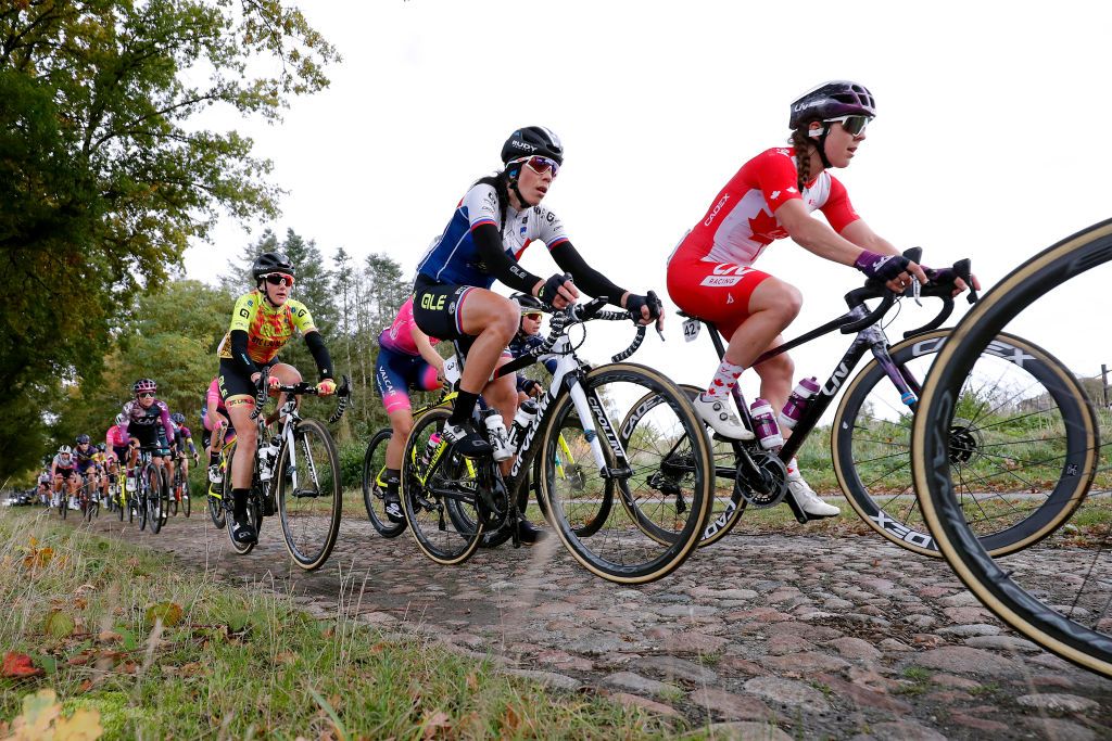 HOOGEVEEN NETHERLANDS OCTOBER 23 LR Laura Tomasi of Italy and Team Ale Btc Ljubljana Eugenia Bujak of Slovenia and Team Ale Btc Ljubljana Alison Jackson of Canada and Team Liv Racing and the peloton compete through cobblestones sector during the 17th UCI Womens WorldTour Ronde van Drenthe 2021 a 1591km one day race from Assen to Hoogeveen UCIWWT RondevDrenthe on October 23 2021 in Hoogeveen Netherlands Photo by Bas CzerwinskiGetty Images