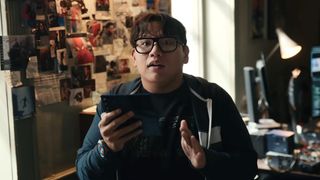 Ned holding Spidey Tracker and looking up at Spider-Man in Spider-Man: Brand New Day