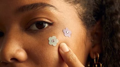 woman wearing some of the acne patches from the article