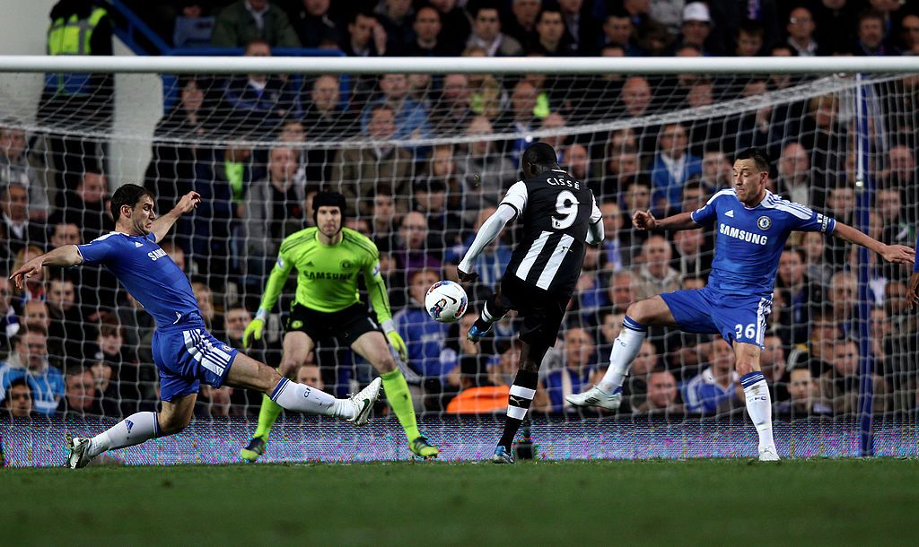 LONDON, ENGLAND - MAY 02: Papiss Cisse of Newcastle scores the opening goal despite the efforts from Branislav Ivanovic (L) and John Terry of Chelsea during the Barclays Premier League match between Chelsea and Newcastle United at Stamford Bridge on May 2, 2012 in London, England. (Photo by Ian Walton/Getty Images)