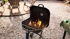 A charcoal grill on gravel 