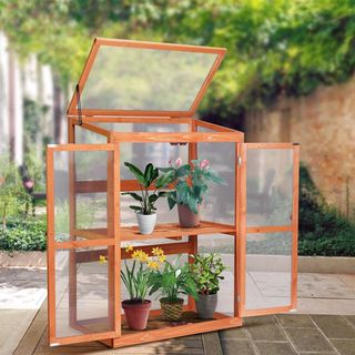 wooden mini greenhouse on a patio