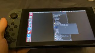 A close up of a Nintendo Switch running Linux with a list of Steam games to install, currently attempting to run FTL: Faster Than Light