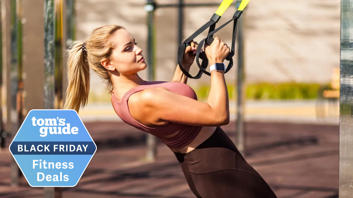 Woman training outside using TRX straps