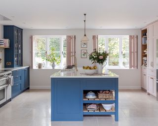 pink kitchen with contrasting blue cabinets