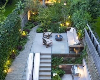 A small residential contemporary family garden with different seating levels