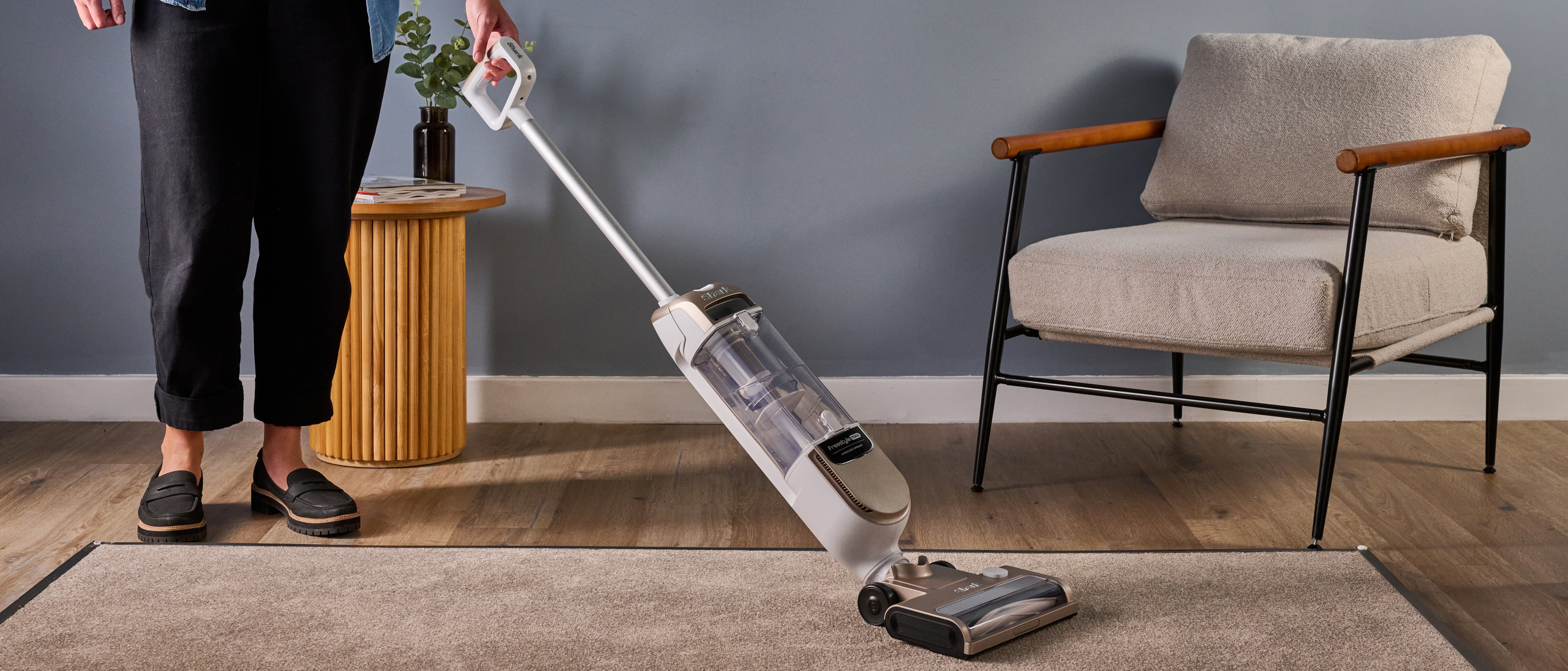Shark Freestyle Pro cordless upright vacuum being tested on a carpet panel